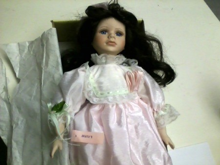 doll with dark hair and wearing pink dress