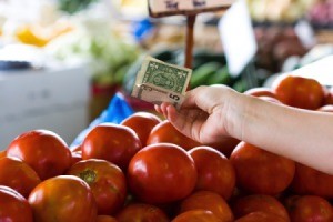 Buying tomatoes with cash.