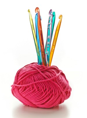 ball of wool with crochet hooks standing up inside
