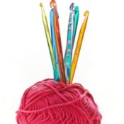 ball of wool with crochet hooks standing up inside