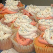 A plate of frosted cupcakes with fairy dust.