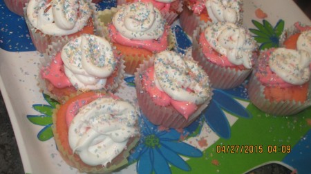 A plate of frosted cupcakes with fairy dust.