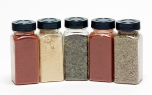 A collection of spice bottles with lids.