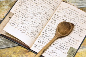 A recipe book with a wooden spoon.