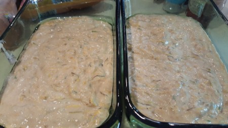 Two glass loaf pans filled with batter.