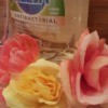 bottle of dish soap with roses in front