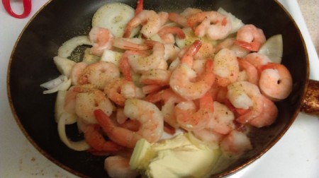 Shrimp cooking with onions.