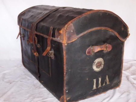 brown trunk with leather straps