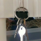 Keys hanging from a binder clip.