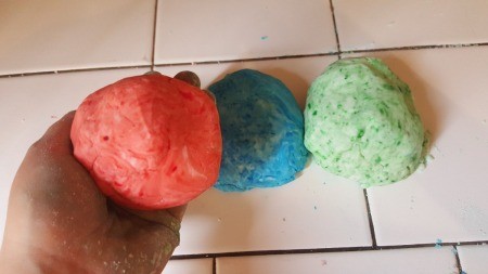 three balls of colored dough