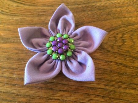 lavender fabric flower with aqua and lavender button in center