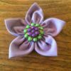 lavender fabric flower with aqua and lavender button in center