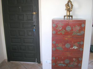 red lacquered cabinet with drawers