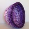 purple hued coiled rag bowl on white background