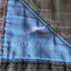 tear in right triangle piece on quilt