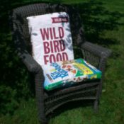 outdoor chair with pillows covered with bird seed and dog food bags
