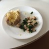 A garlic parmesan chicken dinner on a white plate.