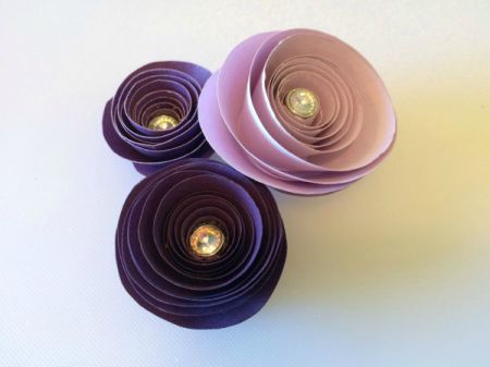 three spiral paper flowers in a cluster