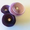 three spiral paper flowers in a cluster