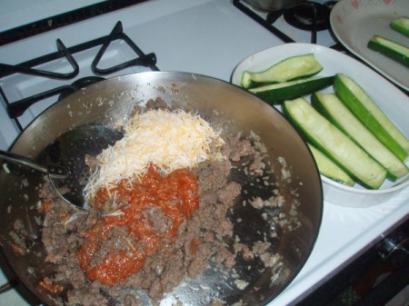 beef, sauce and cheese in pan