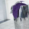 stainless steel laundry basket with dirty towels
