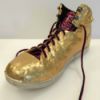 gold duct taped athletic shoe