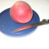 can lid with a peach and knife