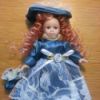 red haired doll wearing a blue dress