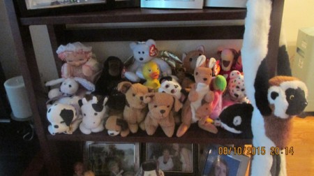 A shelf with stuffed animals and other collectibles.