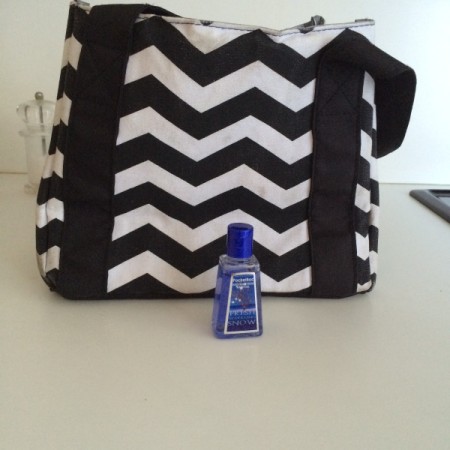 lunch box with small bottle of hand sanitizer next to it