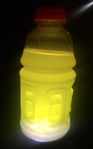 A sports drink with a light behind it, making a lantern.