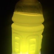 A sports drink with a light behind it, making a lantern.