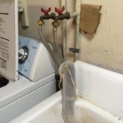 hose over drain pipe emptying into utility sink