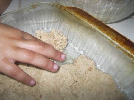 patting dough in pan
