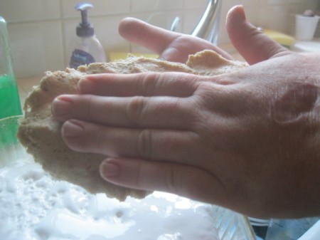 patting dough in hand