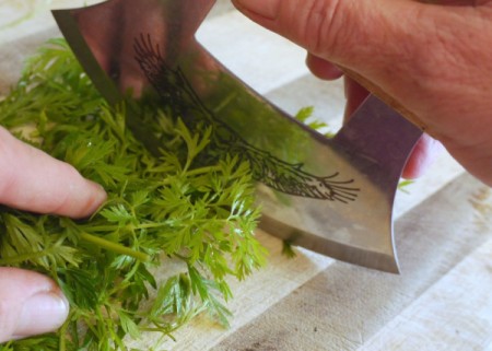 chopping carrot tops