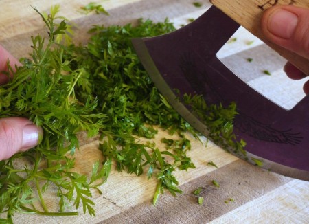 chopping carrot tops