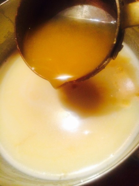 pouring sauce into pudding