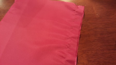 A pink fabric for lining a purse.