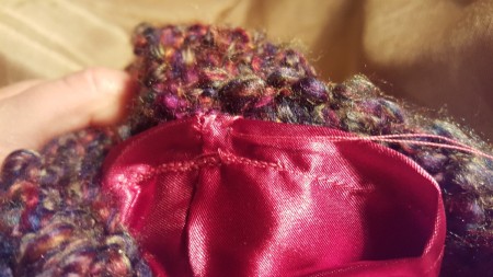 Sewing the lining into a handmade purse.