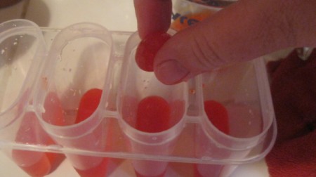 Fizzy Cherry Popsicles - dropping cherries in mold