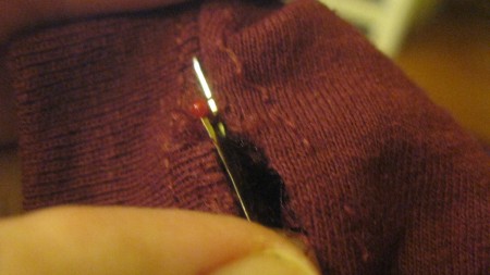 Pinning a t-shirt to be sewn.