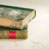 Two old ornate hardcover books.
