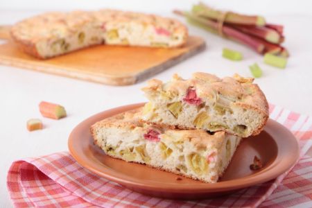 round flat rhubarb bread/cake with slice in foreground
