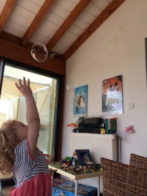 child chasing a bubble