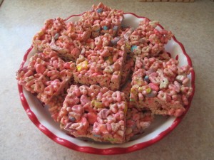 Squares of treats made with Lucky Charms cereal.