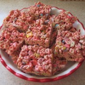 Squares of treats made with Lucky Charms cereal.