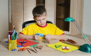 boy making Christmas decorations