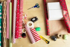 paper, scissors, tape, and other gift wrap supplies