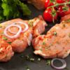 raw pork steaks with tomatoes and onions
